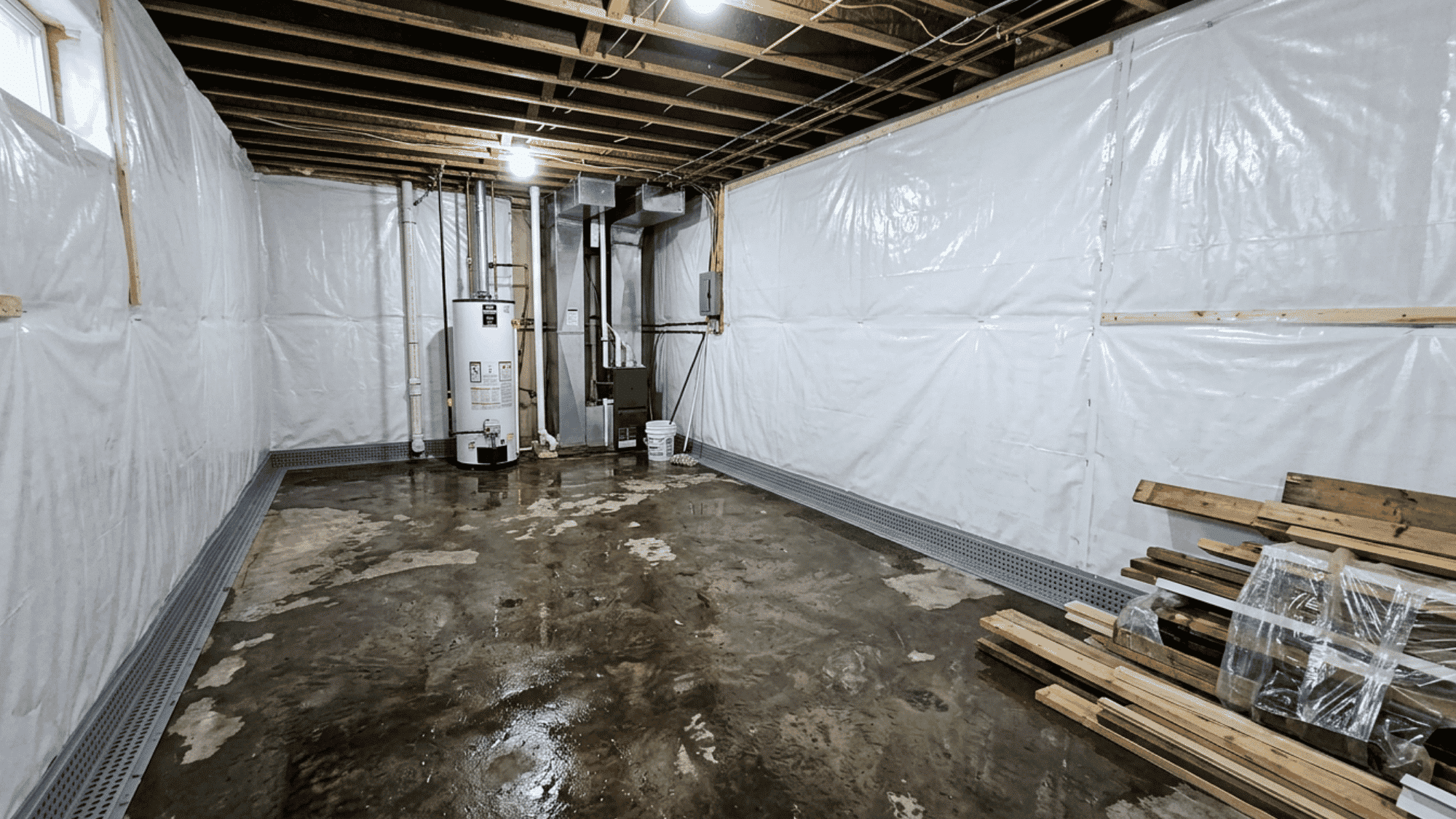 Cross-section diagram showing proper installation of a basement wall vapor barrier system
