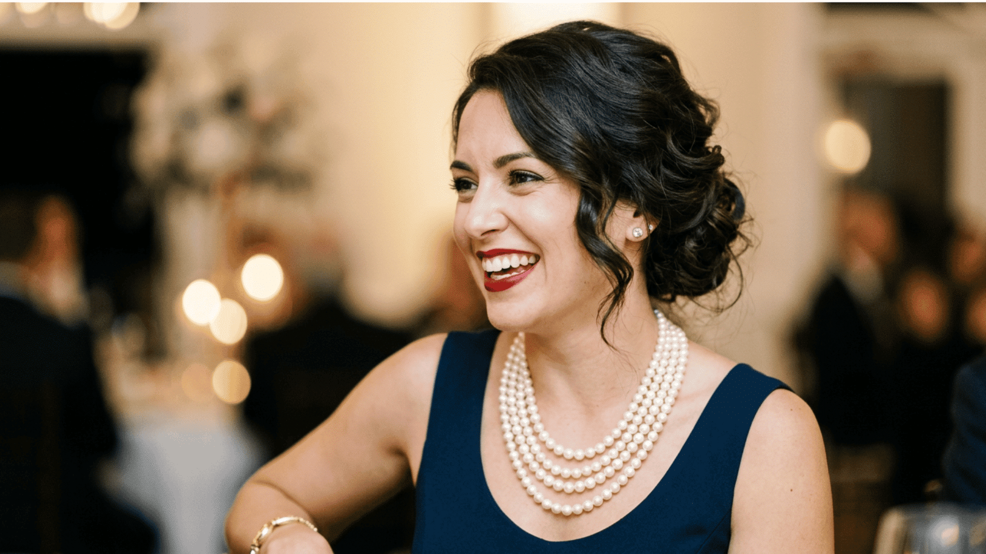 Woman wearing pearl jewelry with a classic vintage evening look.
